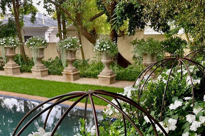 Tuscan garden with urn on plinth Tuscan garden with urn on plinth