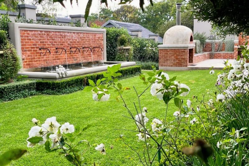 Tuscan style garden with water feature and pizza oven Tuscan style garden with water feature and pizza oven